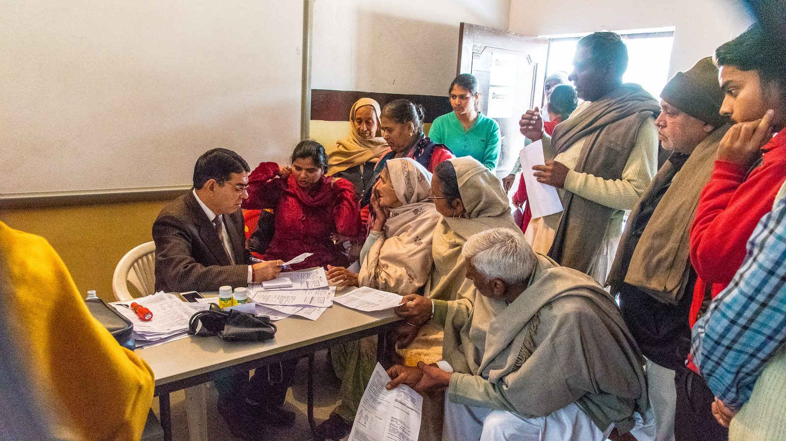 Villagers being seen by a doctor at a One Life At A Time medical camp