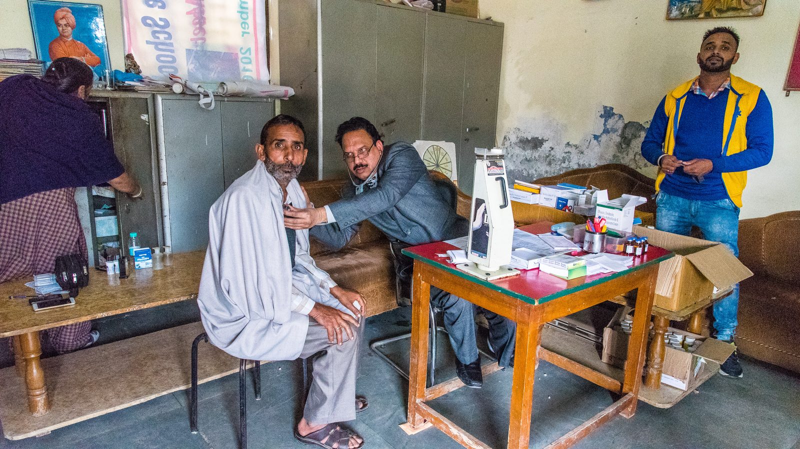 A doctor examining a patient at a medical camp