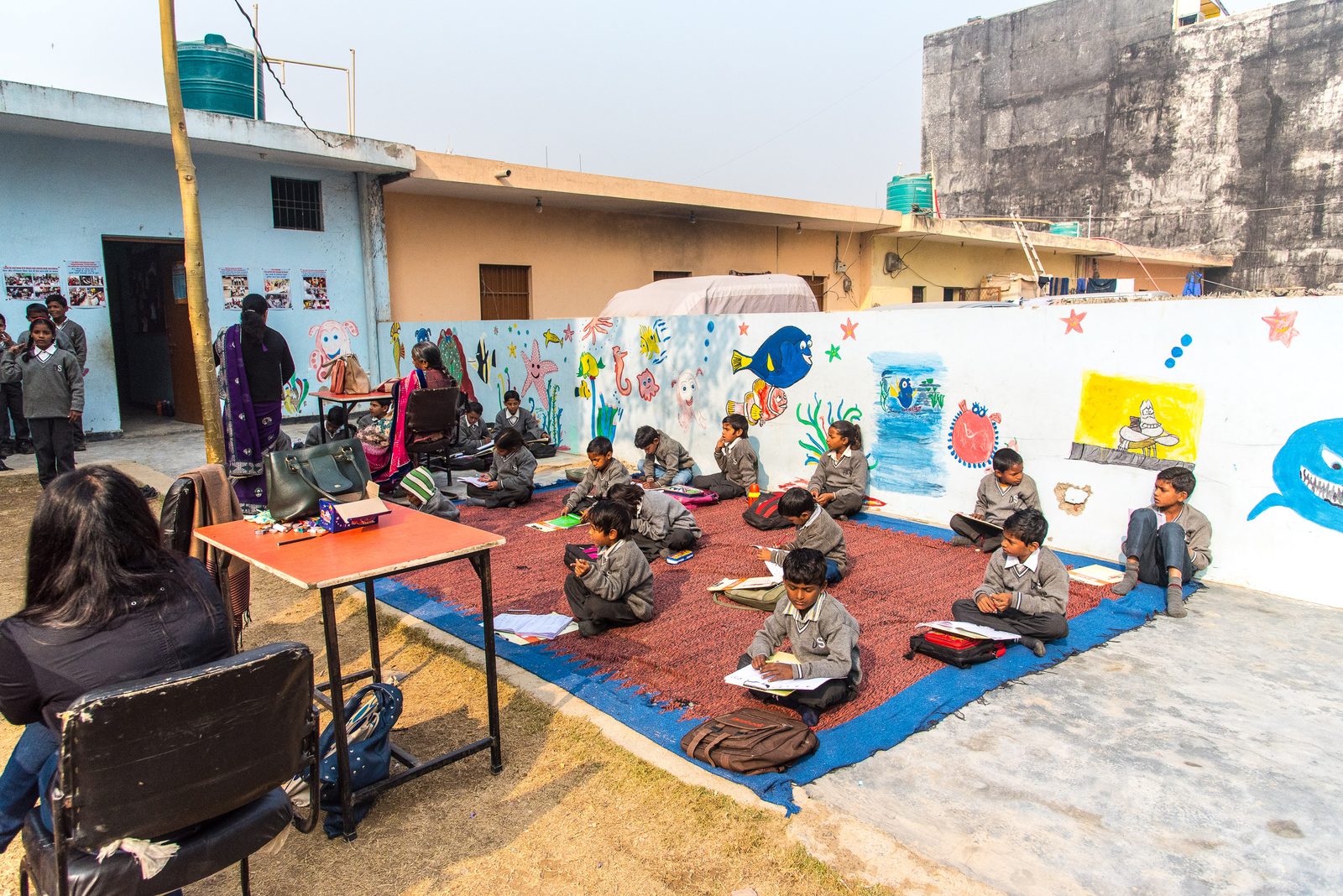 Children learning in an open-air classroom in a rural Indian village