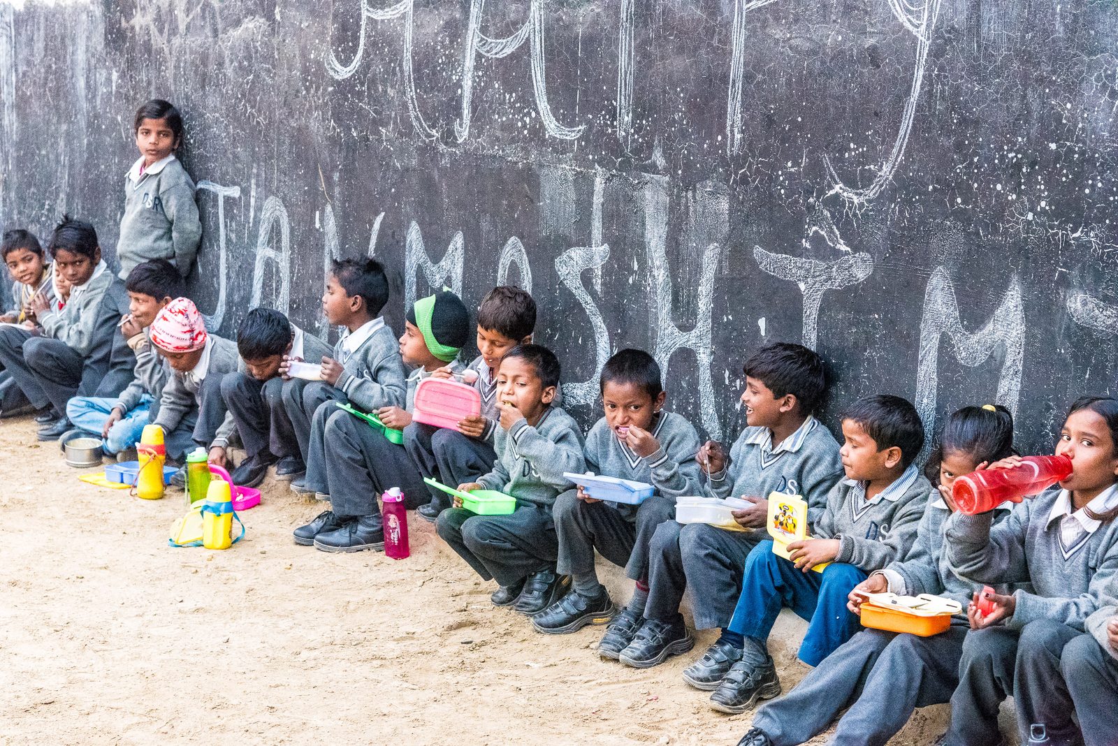 Schoolchildren sitting together during a lunch break