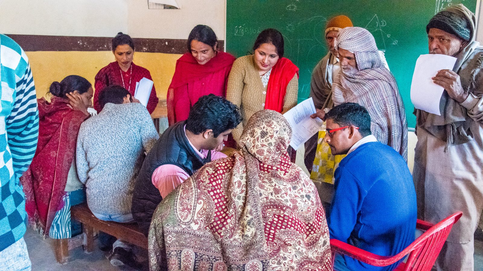 Community members gathering at an outreach session