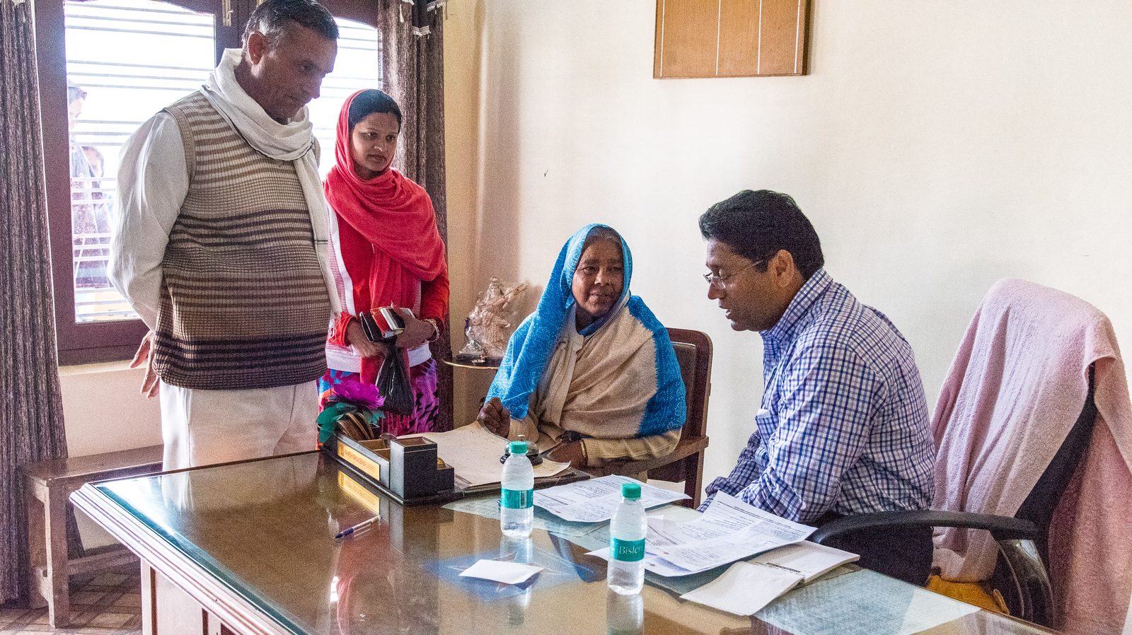 A doctor consulting an elderly woman and her family at a medical camp